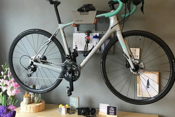 Grey road bike hanging system on the wall