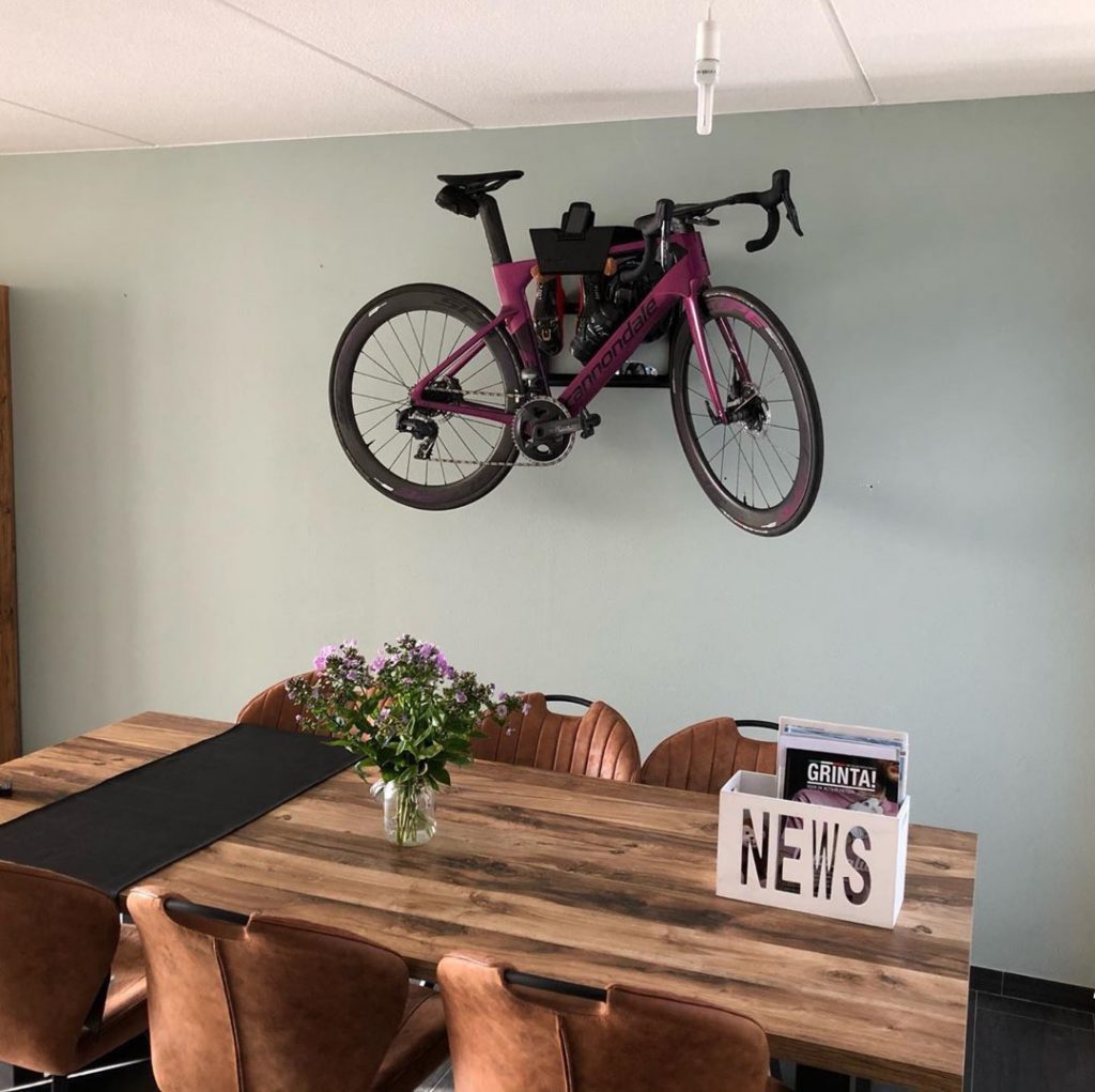 hanging up a racing bike in the living room